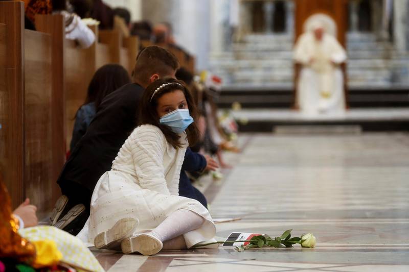 A girl sits down before Pope Francis holds a prayer at the Grand Immaculate Church in the town of Qaraqosh. Reuters