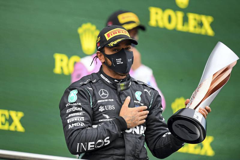 Mercedes' British driver Lewis Hamilton celebrates on the podium after winning the Turkish Formula One Grand Prix at the Intercity Istanbul Park circuit in Istanbul on November 15, 2020. - Lewis Hamilton won the race to seal his 7th World Championship. (Photo by Clive Mason / POOL / AFP)