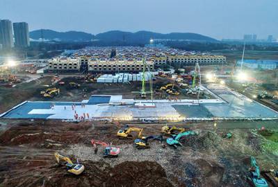 Excavators and workers are seen at the construction site where the new Huoshenshan Hospital is being built to treat patients of a new coronavirus on the outskirts of Wuhan, China January 27, 2020. Picture taken January 27, 2020. China Daily via REUTERS ATTENTION EDITORS - THIS IMAGE WAS PROVIDED BY A THIRD PARTY. CHINA OUT.