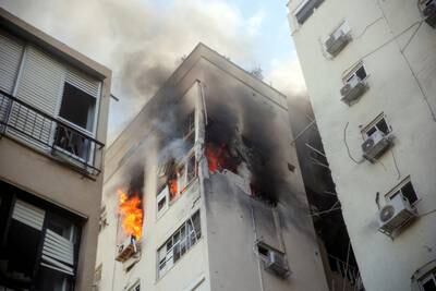 A building in Tel Aviv ablaze following rocket attacks from the Gaza Strip, in Tel Aviv, Israel. Reuters