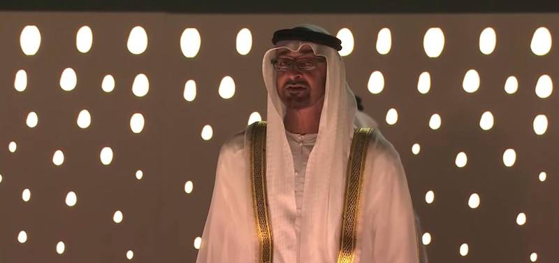 Sheikh Mohamed bin Zayed, Crown Prince of Abu Dhabi and Deputy Supreme Commander of the Armed Forces, stands for the national anthem and sings its verses during the 'Seeds of the Union' National Day show. Courtesy: UAE National Day