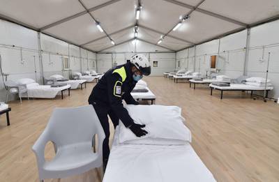 An officer of the 'Protezione Civile' Civil Protection Department prepares the site of new hospital for the Covid-19 established at Hall 5 of Torino Esposizioni (exhibition complex of the Piedmontese capital) at the Parco del Valentino, Turin, Italy. EPA