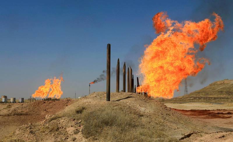 FILE PHOTO: Flames emerge from flare stacks at the oil fields in Kirkuk, Iraq October 18, 2017. REUTERS/Alaa Al-Marjani/File Photo