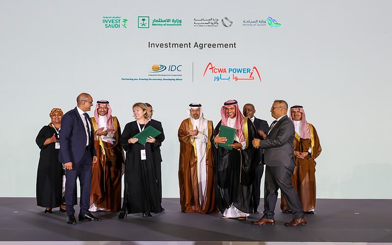 Paddy Padmanathan, of Acwa Power, Joanne Bate, of Industrial Development Corporation of South Africa, and other executives sign an agreement to explore green hydrogen projects. Photo: Acwa Power