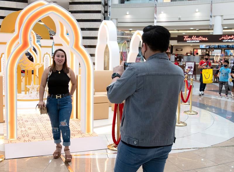 Visitors stop for photos at Al Wahda Mall. Victor Besa / The National