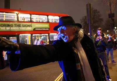 An anti-lockdown protester gestures during a demonstration and a New Year's celebration in London. Reuters