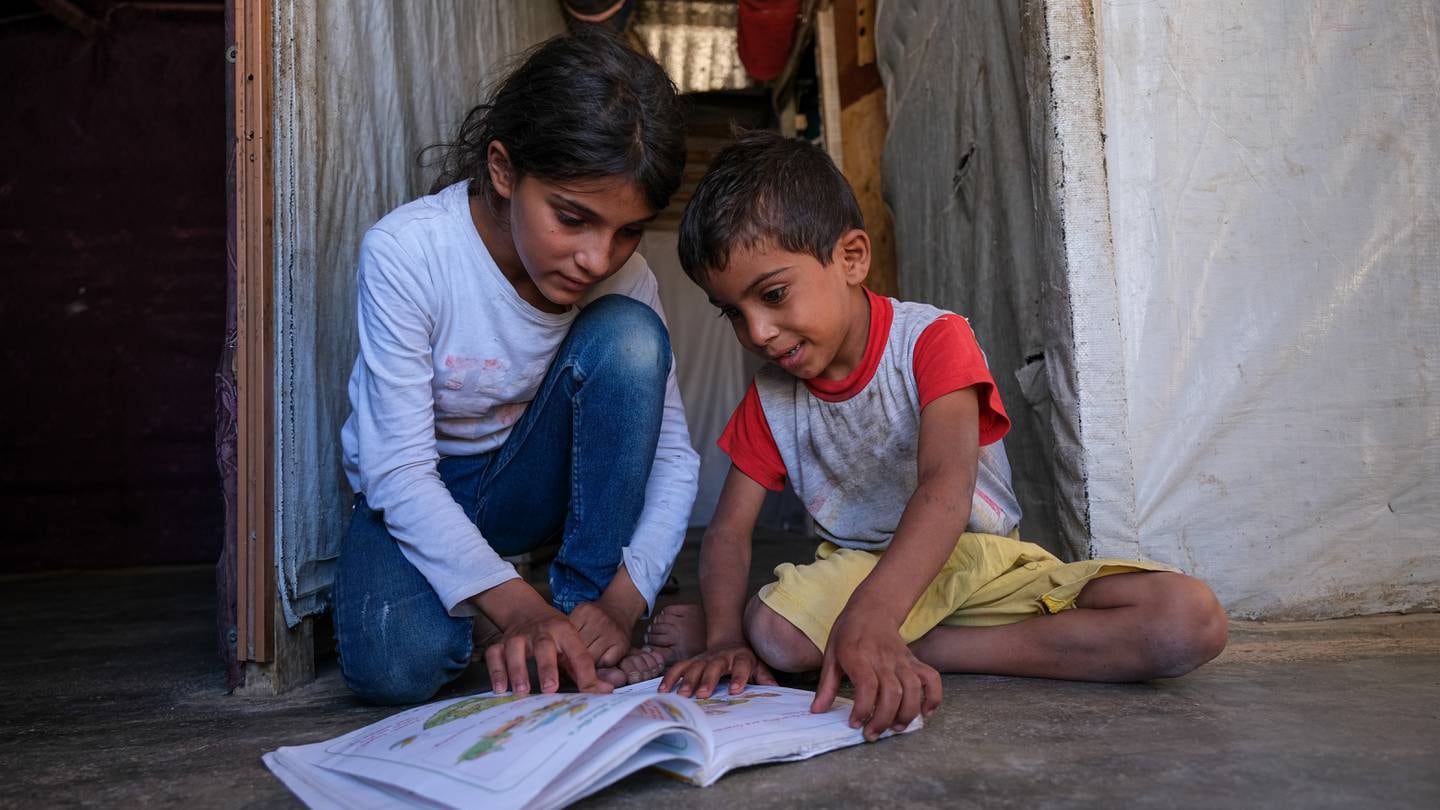 Hazar, left, with her brother at their home on the outskirts of Bar Elias. Photo: NRC
