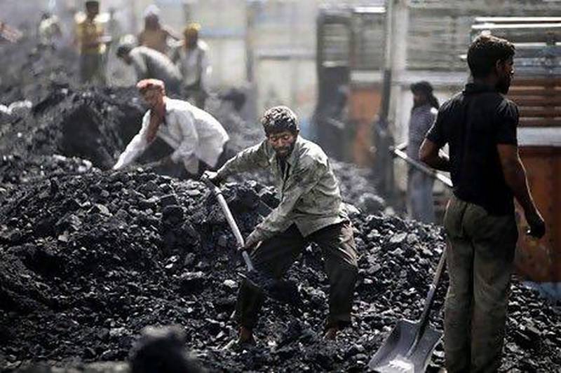 Labourers load coal onto trucks at a depot on the outskirts of Jammu, in Jammu and Kashmir. India depends on coal for 65 per cent of its power generation needs.
