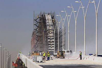Construction workers build a project on King Abdullah Road in Riyadh in February. Fahad Shadeed / Reuters
