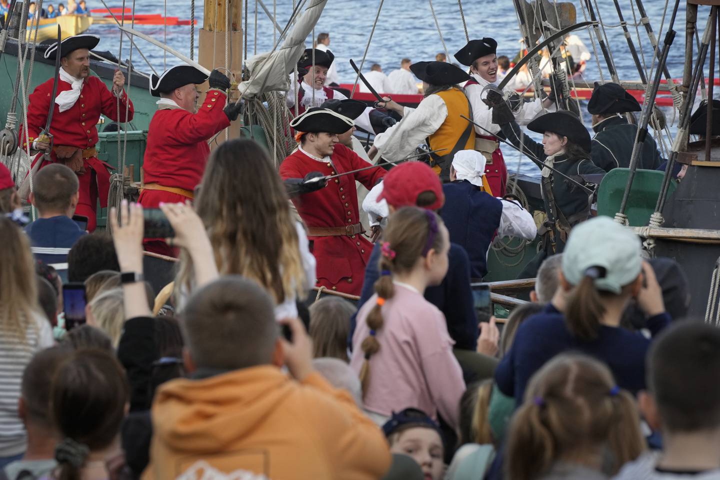 People watch a reconstruction of a battle between Russian and Sweden sailors during festivities marking the 350th birthday of Russian Tsar Peter the Great in St. Petersburg. AP