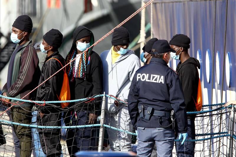 Migrants disembark a rescue vessel at Bari harbour in Italy. EPA
