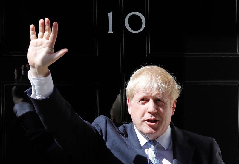 FILE - In this file photo dated Wednesday, July 24, 2019, Britain's Prime Minister Boris Johnson waves from the steps outside 10 Downing Street in London.  In a letter released Wednesday Aug. 28, 2019, Prime Minister Johnson has written to fellow lawmakers explaining his decision to ask Queen Elizabeth II to suspend Parliament as part of the government plans before the Brexit split from Europe. (AP Photo/Frank Augstein, FILE)