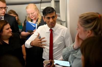 Mr Sunak speaking to journalists on a plane while travelling to the Nato summit. PA