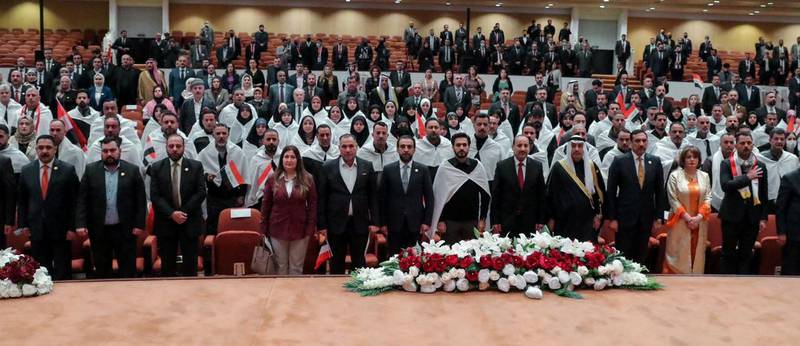 Iraq's re-elected parliament Speaker Mohammed Al Halbousi with the newly elected MPs in Baghdad on January 9.  Reuters
