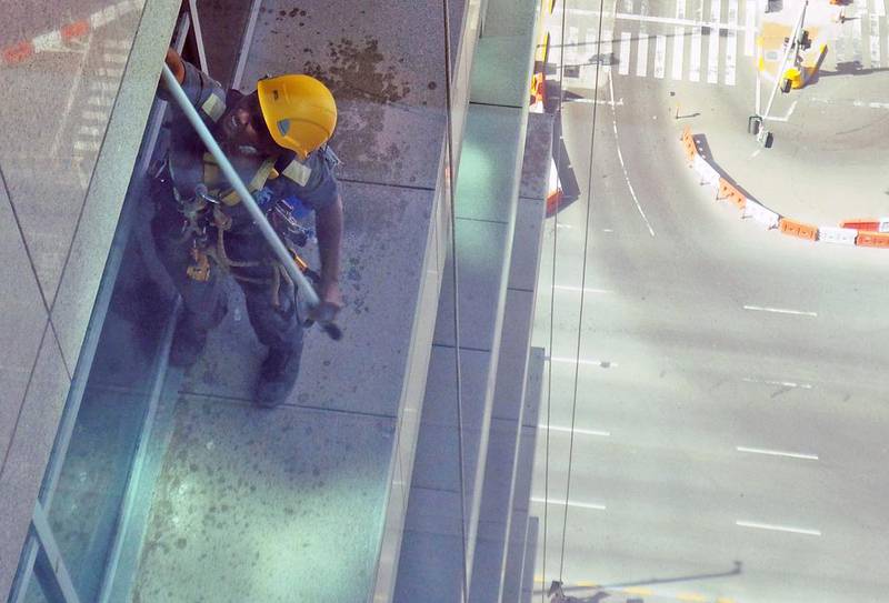 Window cleaners precariously perched on the ledge of Abu Dhabi Mall. Courtesy Ramesh Menon