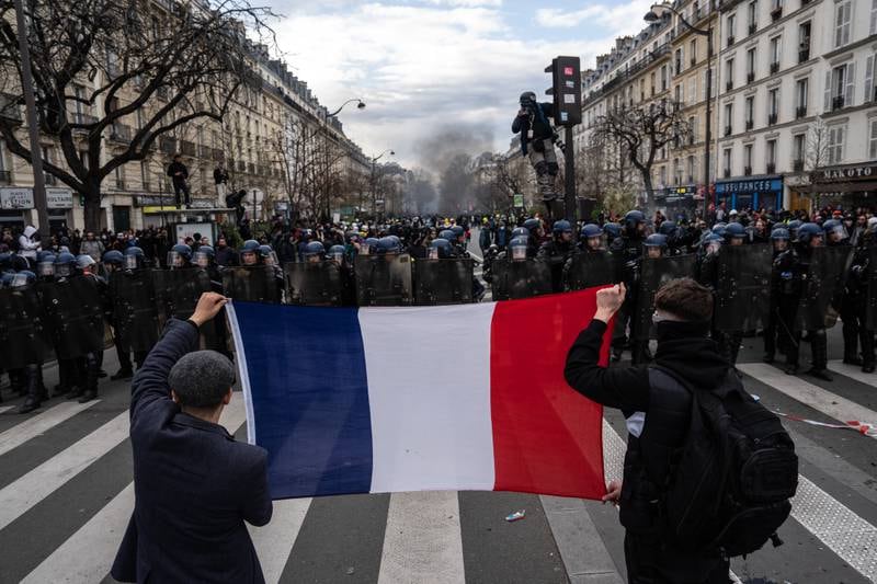Protesters hold up a French flag during a rally in Paris in March. Getty Images