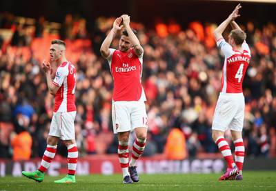 Olivier Giroud, centre, of Arsenal celebrates with teammates after a Premier League match at Emirates Stadium on March 14, 2015 in London, England. (Photo by Ian Walton/Getty Images)