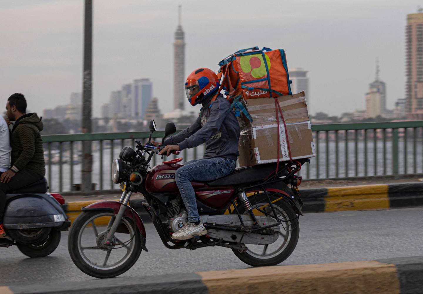 A delivery worker rides his motorbike in Cairo. Egyptian e-commerce market revenue is expected to reach $15.76 billion by 2027. AFP