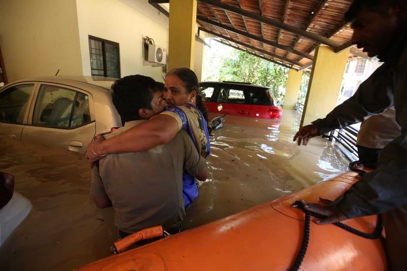 Firefighters rescue people from their houses submerged by water. EPA