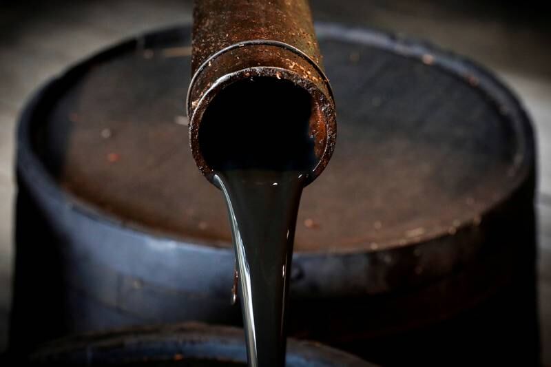 FILE PHOTO: Oil pours out of a spout from Edwin Drake's original 1859 well that launched the modern petroleum industry at the Drake Well Museum and Park in Titusville, Pennsylvania U.S., October 5, 2017. REUTERS/Brendan McDermid/File Photo