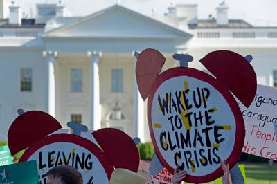 Protesters gather outside the White House in Washington to protest against Donald Trump's decision to withdraw the US from the Paris climate change accord. AP