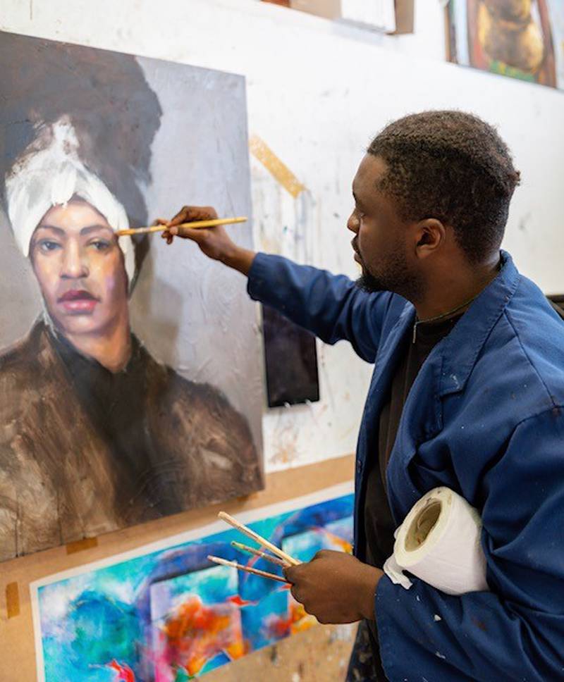 Victor Sitali, an artist from Zambia, works on a painting. Photo: Victor Sitali