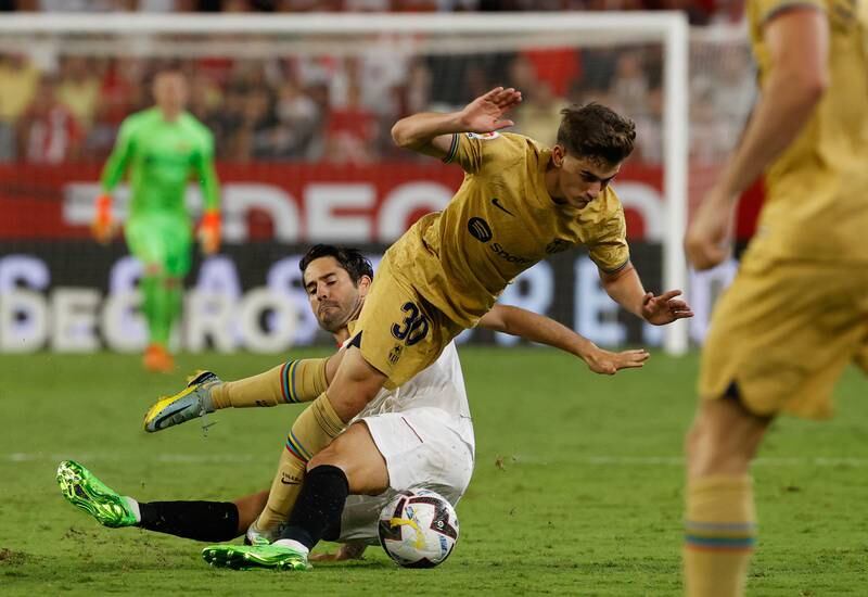 Sevilla striker Isco Alarcon tackles Barcelona midfielder Gavi. EPA