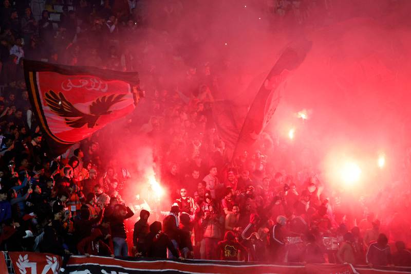 Ahly supporters cheer for their team and set off flares inside the stadium. AFP