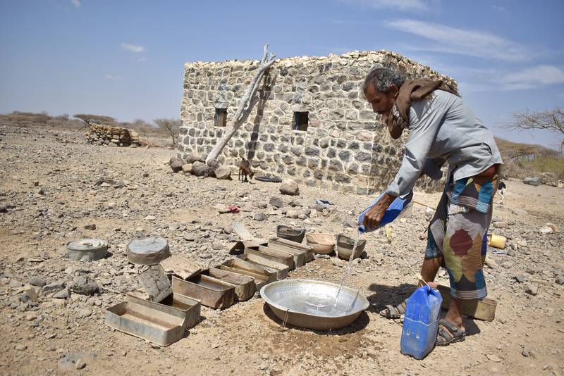 Abdullah, 35, pours water for his goats into empty storage containers for bullets and
soldier’s helmets, the remnants of Yemen’s ongoing seven-year conflict. He gestures to an
anti-tank mine lying on the ground nearby:
“There are mines everywhere here. Sometimes our sheep or camels set off the landmines
and they explode, but you can see them everywhere on the ground.” Photo: Cherry Franklin for DRC