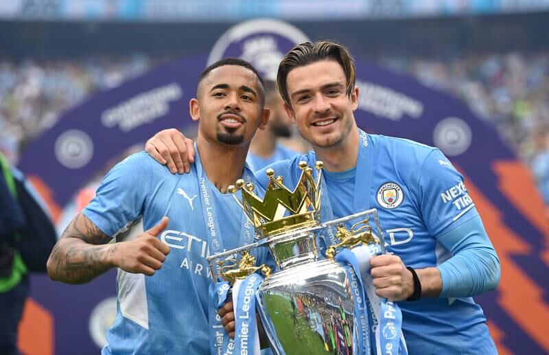 Gabriel Jesus and Jack Grealish celebrate with the Premier League trophy. Getty