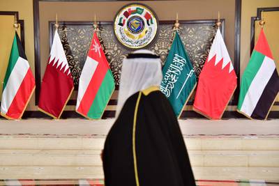 A man walks past the flags of the countries attending the Gulf Cooperation Council (GCC) summit at Bayan palace in Kuwait City on December 5, 2017.
The Gulf Cooperation Council, which launches its annual summit today in Kuwait amid its deepest ever internal crisis, comprises six Arab monarchies who sit on a third of the world's oil. A political and economic union, the GCC comprises Saudi Arabia, the United Arab Emirates, Kuwait, Qatar, Oman and Bahrain. Dominated by Riyadh, it is a major regional counterweight to rival Iran.
 / AFP PHOTO / GIUSEPPE CACACE