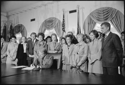 Ms Carter stands to the right as her husband signs the Extension of Equal Rights Amendment ratification at the White House in October 1978. Photo: US National Archives