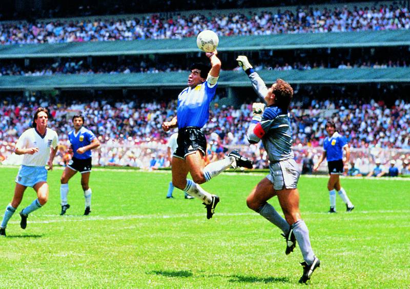 Diego Maradona scores the infamous 'Hand of God' goal against England during the 1986 World Cup quarter-final. The ball will go under the hammer next month and could fetch more than $3 million. Photo: ABACA