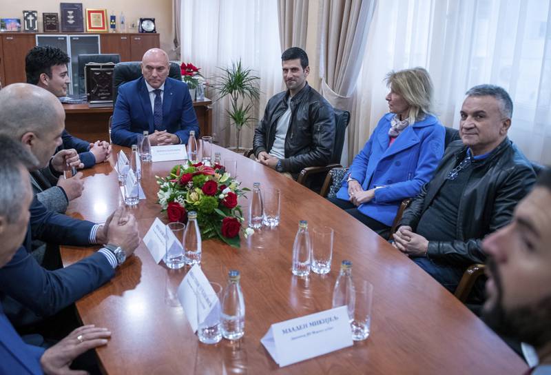 Novak Djokovic with his mother Dijana and father Srdjan with local officials in Budva, Montenegro. AP