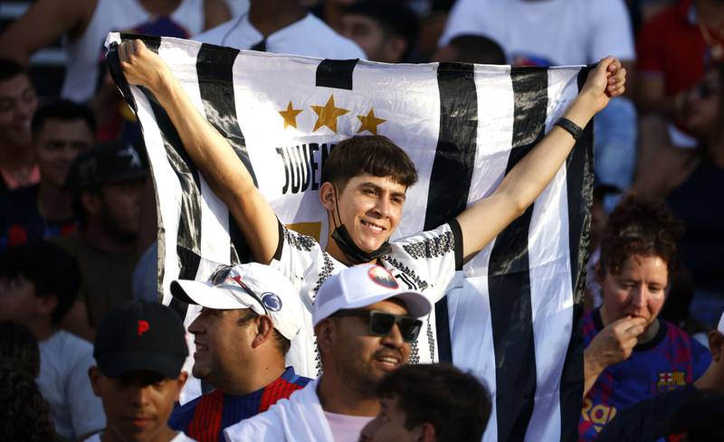 A fan of Juventus waves a flag before the match at the Cotton Bowl. AFP
