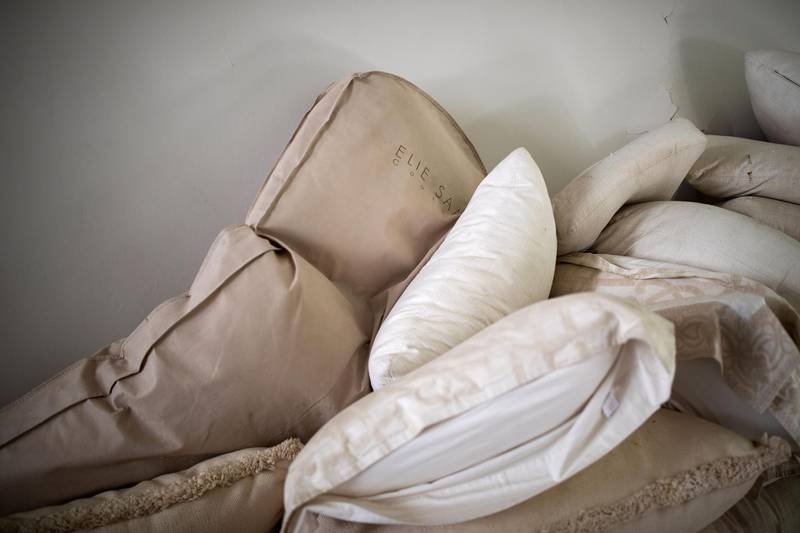 A garment cover is strewn among pillows at Saab's home.