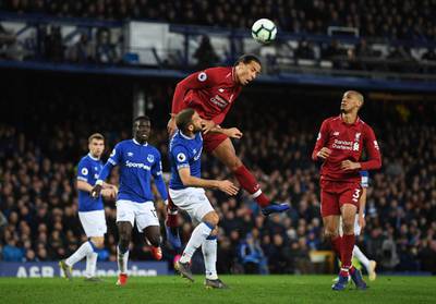 LIVERPOOL, ENGLAND - MARCH 03:  Virgil van Dijk of Liverpool outjumps Cenk Tosun of Everton  during the Premier League match between Everton FC and Liverpool FC at Goodison Park on March 03, 2019 in Liverpool, United Kingdom. (Photo by Shaun Botterill/Getty Images)