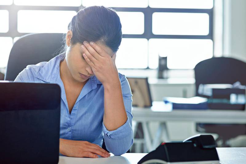 Shot of a businesswoman experiencing stress at work