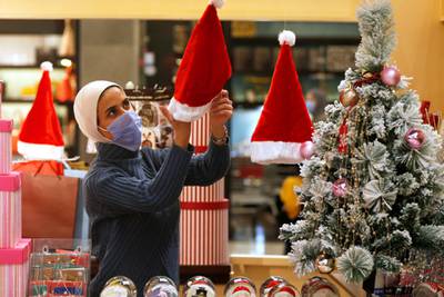 A woman displays gifts in her store ahead of Christmas at a mall, amid fears over rising numbers of Covid-19 cases in Amman, Jordan, December 15. Reuters