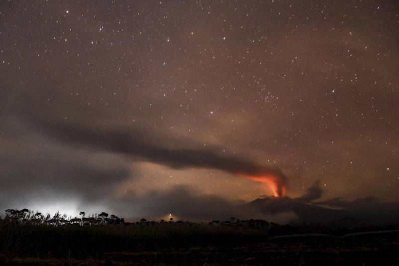Volcanic ash and clouds are illuminated by lava from the crater of Mount Raung as seen from Songgon, Banyuwangi East Java, Indonesia on July 11, 2015. Reuters/Zabur Karuru/Antara Foto 