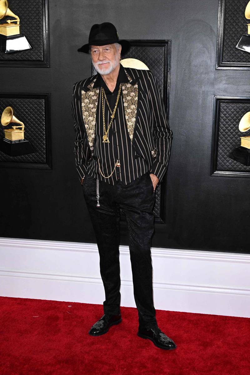 Mick Fleetwood wears a pinstripe blazer with gold lapels and his signature hat. AFP