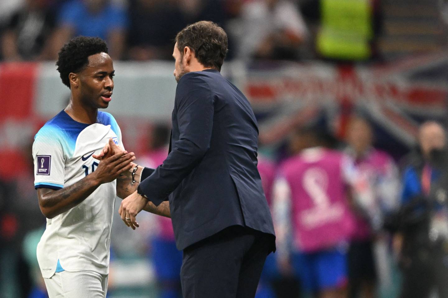 England forward Raheem Sterling shakes hands with head coach Gareth Southgate as he leaves the pitch. AFP