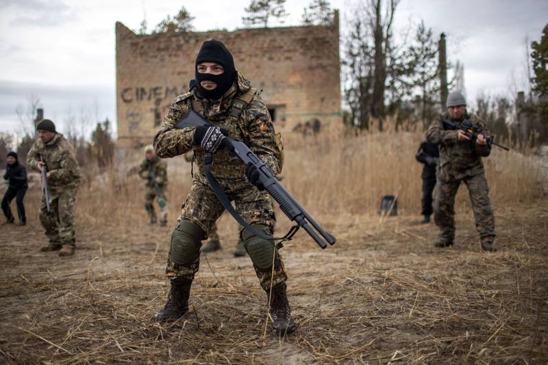 Ukraine's Territorial Defence Forces participate in firearm drills at a former asphalt factory on the outskirts of Kiev. Bloomberg