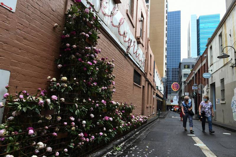 People walk past a floral display at Crossley Street in Melbourne, Australia. EPA