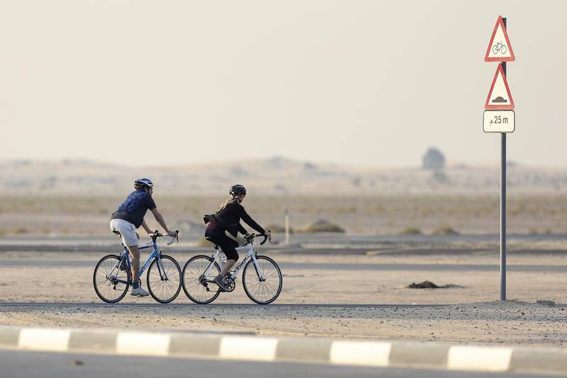 A pair of cyclists at Al Qudra Cycle Track in Dubai. Sarah Dea / The National



