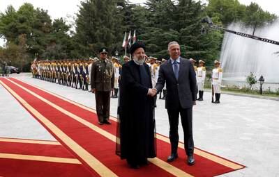 Iranian President Ebrahim Raisi and Iraqi Prime Minister Mustafa Al Kadhimi pose for a photo after reviewing the honour guard during a welcome ceremony in Tehran. All photos: EPA