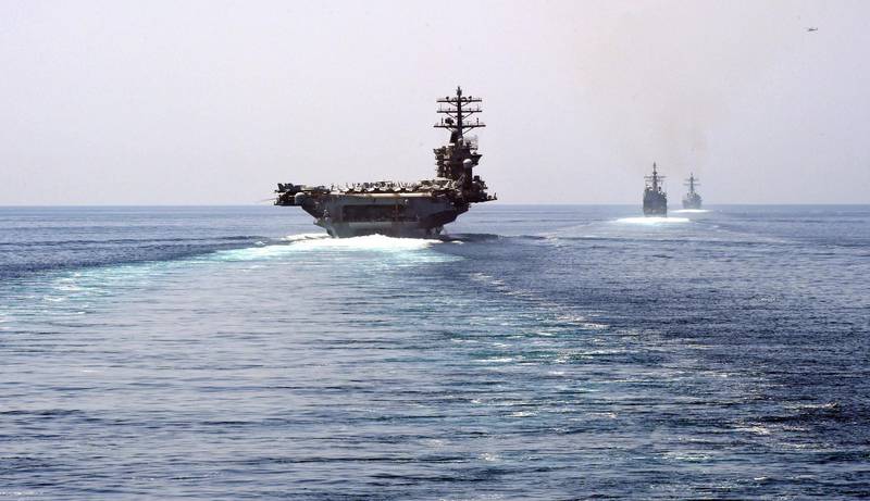In this image released by the US Navy, (L-R) the aircrat carries USS Nimitz, the guided-missile cruiser USS Princeton and guided-missile destroyer USS Sterett transits the Strait of Hormuz on September 18, 2020. - The Nimitz group passed the Strait of Hormuz to enter the Gulf on September 18, amid Washington threats to enforce "UN" sanctions without the backing of Security Council partners, the US Navy announced. The strike group led by the Nimitz and including two guided-missile cruisers and a guided-missile destroyer sailed into the Gulf to operate and train with US partners and support the coalition fighting the Islamic State group, the US 5th Fleet said in a statement. (Photo by Indra Beaufort / US NAVY / AFP) / RESTRICTED TO EDITORIAL USE - MANDATORY CREDIT "AFP PHOTO / US Navy / Mass Communication Specialist 2nd Class Indra Beaufort" - NO MARKETING - NO ADVERTISING CAMPAIGNS - DISTRIBUTED AS A SERVICE TO CLIENTS