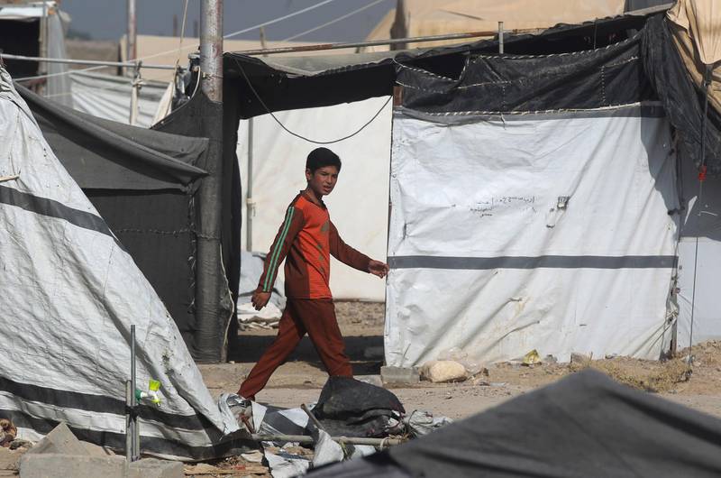 An Iraqi boy walks though the displaced persons camp in Habbaniyah in Iraq's Anbar province. AFP