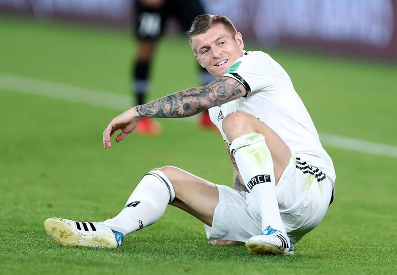 Abu Dhabi, United Arab Emirates - December 22, 2018: Toni Kroos of Real Madrid smiles as he is tackled during the match between Real Madrid and Al Ain at the Fifa Club World Cup final. Saturday the 22nd of December 2018 at the Zayed Sports City Stadium, Abu Dhabi. Chris Whiteoak / The National