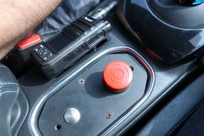 A red button allows the safety officer to intervene in case something goes wrong in the fully autonomous taxi.